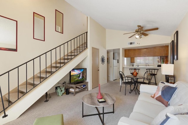 carpeted living room featuring lofted ceiling and ceiling fan