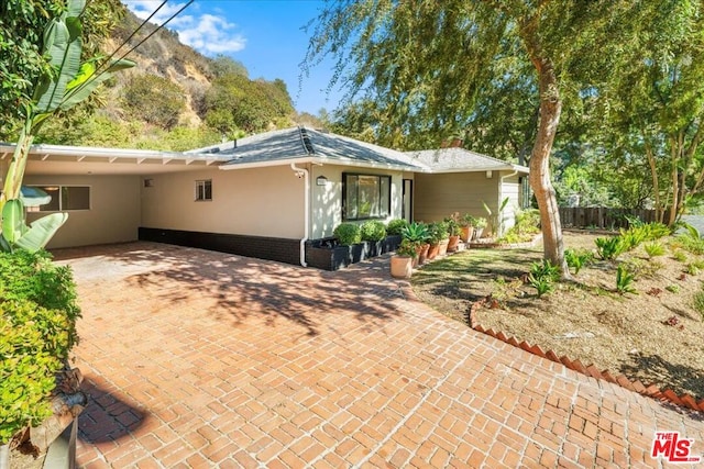 rear view of house featuring a carport