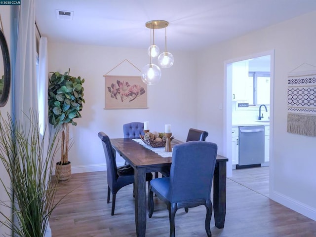 dining area with sink and hardwood / wood-style floors