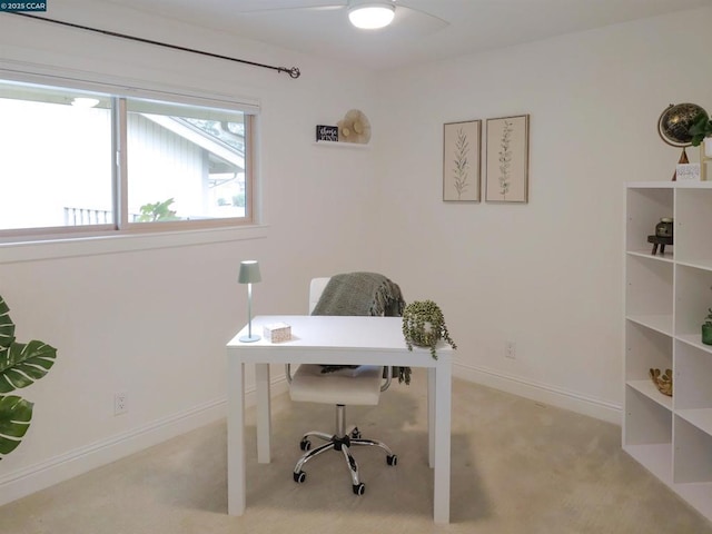 carpeted office featuring ceiling fan