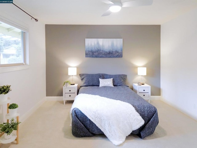 bedroom featuring light colored carpet and ceiling fan