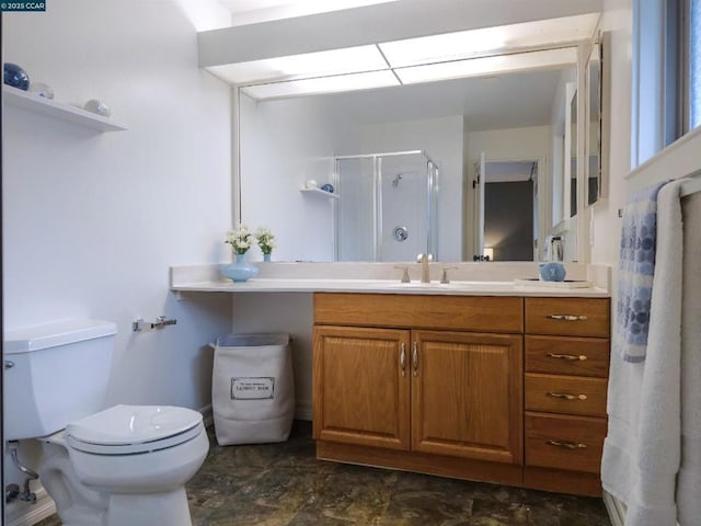 bathroom with vanity, a shower with shower door, and toilet