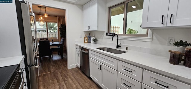 kitchen featuring sink, stainless steel appliances, white cabinets, and light stone countertops