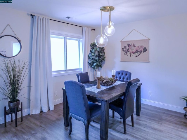 dining space featuring dark hardwood / wood-style flooring