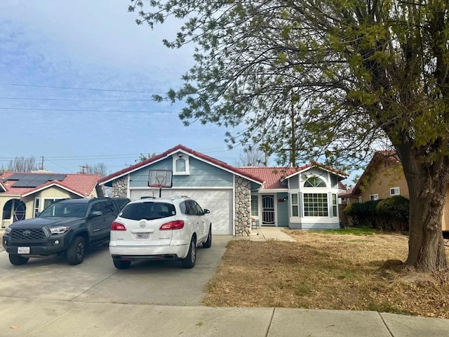 ranch-style house featuring a garage and a front lawn