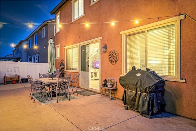 patio at night featuring area for grilling