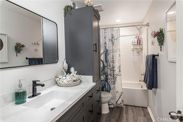 full bathroom featuring vanity, wood-type flooring, toilet, and shower / bath combo with shower curtain