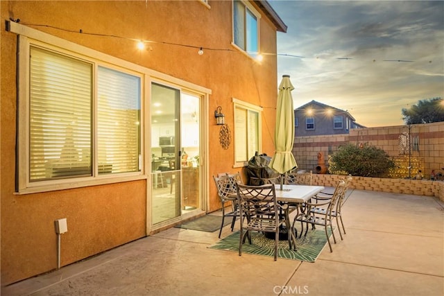 view of patio terrace at dusk