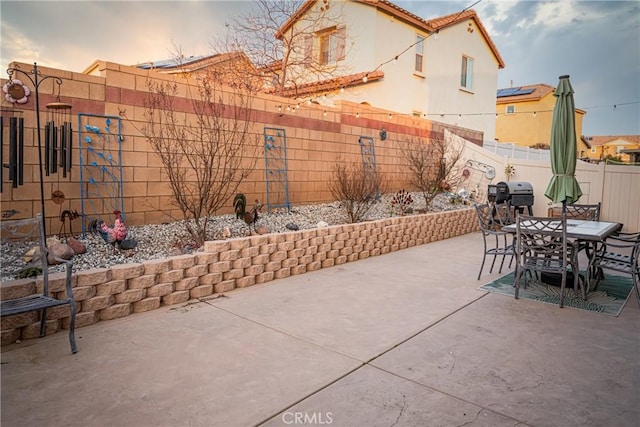 patio terrace at dusk with a grill