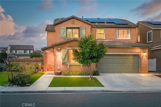 view of front of property featuring a garage and solar panels