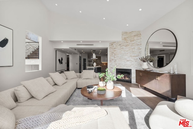 living room featuring a stone fireplace