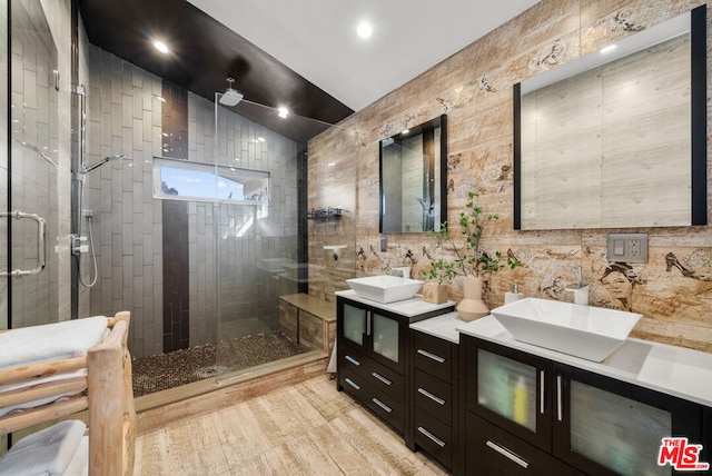 bathroom featuring vanity and a shower with door