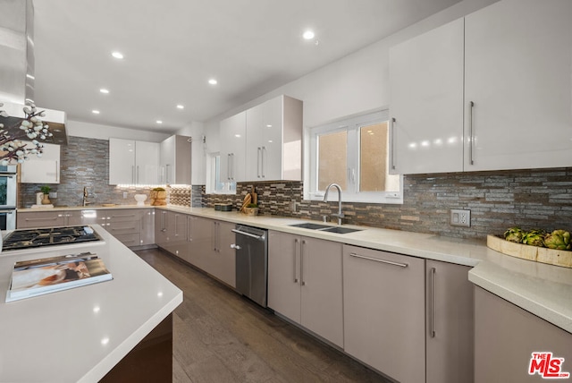 kitchen with tasteful backsplash, sink, and white cabinets