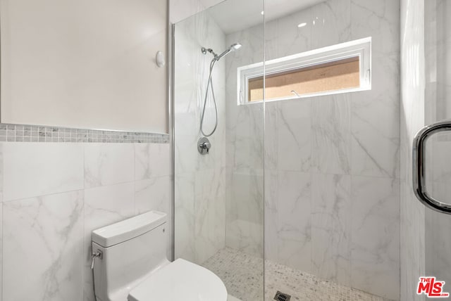 bathroom with an enclosed shower and toilet