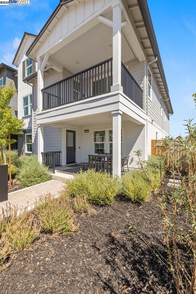 rear view of property featuring a balcony