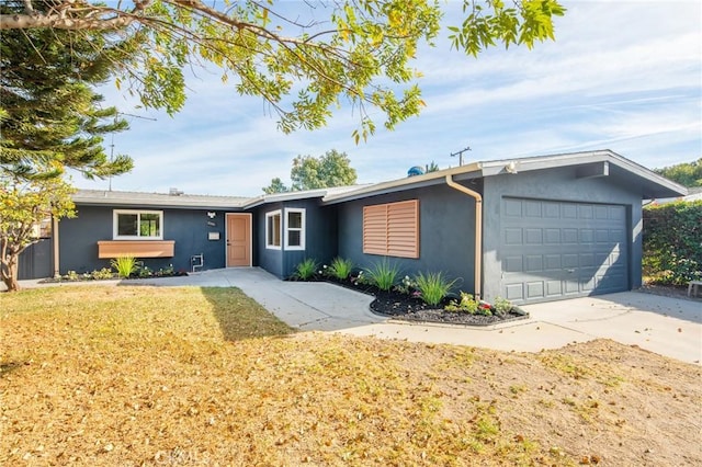 ranch-style house with a garage and a front lawn