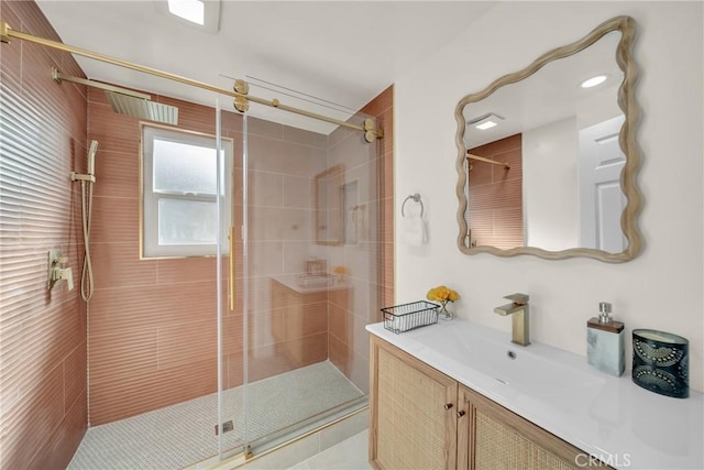 bathroom featuring vanity and a shower with shower door