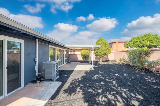 view of yard featuring a patio and central air condition unit