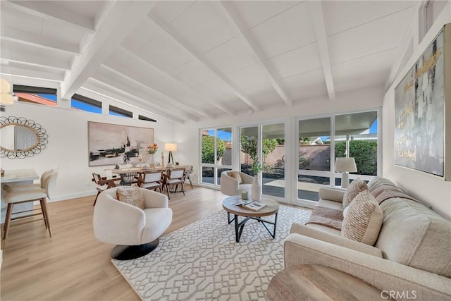 living room with hardwood / wood-style flooring and lofted ceiling with beams