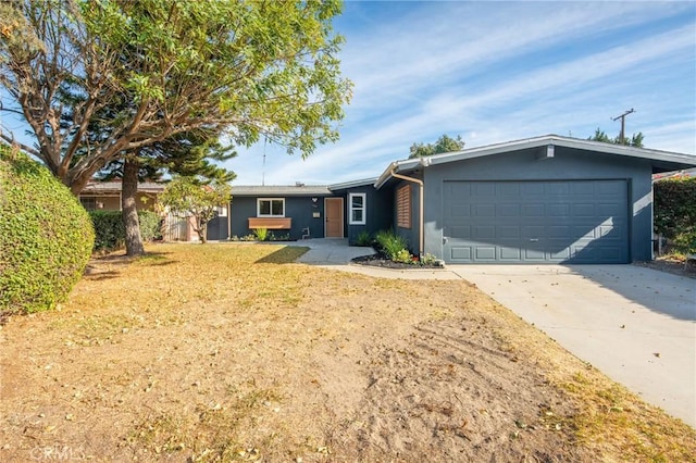 ranch-style home with a garage and a front yard