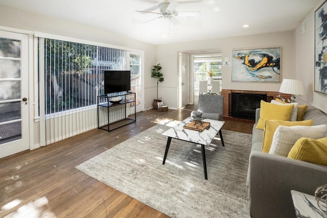 living room featuring dark hardwood / wood-style floors and ceiling fan