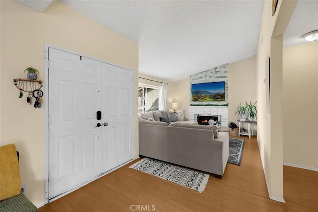 living room with hardwood / wood-style flooring and vaulted ceiling