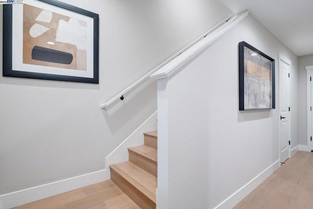 stairs with hardwood / wood-style flooring