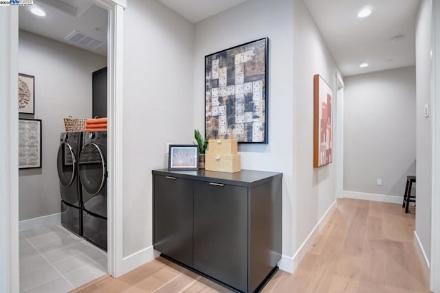 interior space with light hardwood / wood-style floors and washing machine and clothes dryer