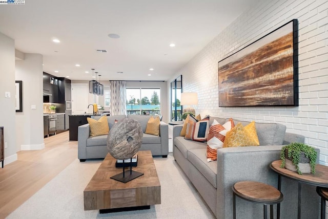 living room with brick wall and sink