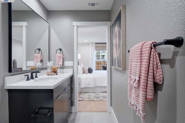 bathroom with tile patterned flooring and vanity