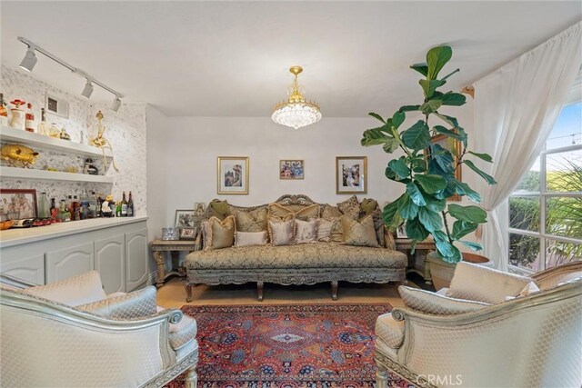 living area with track lighting and a chandelier