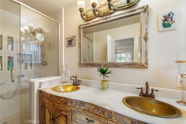 bathroom with vanity and a shower with door