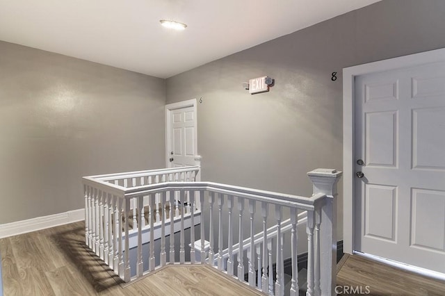 bedroom with hardwood / wood-style flooring and a crib