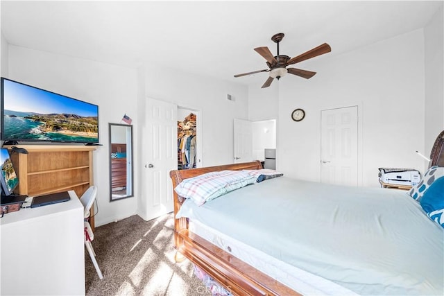 bedroom featuring lofted ceiling, carpet, a spacious closet, ceiling fan, and a closet