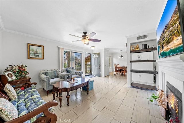 living room featuring ornamental molding and ceiling fan