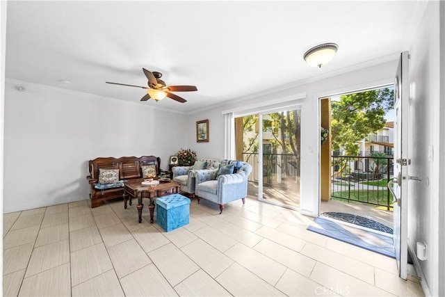 living room featuring ornamental molding and ceiling fan