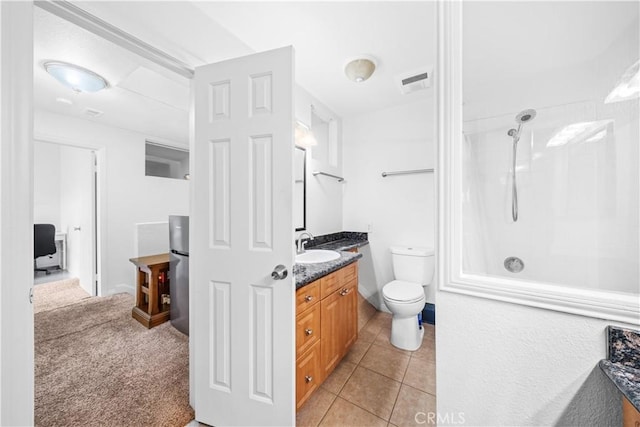 bathroom with vanity, a shower, tile patterned floors, and toilet