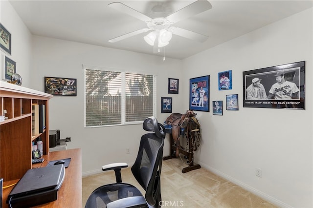 carpeted office featuring ceiling fan