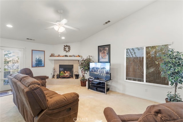 carpeted living room featuring ceiling fan, a fireplace, and vaulted ceiling