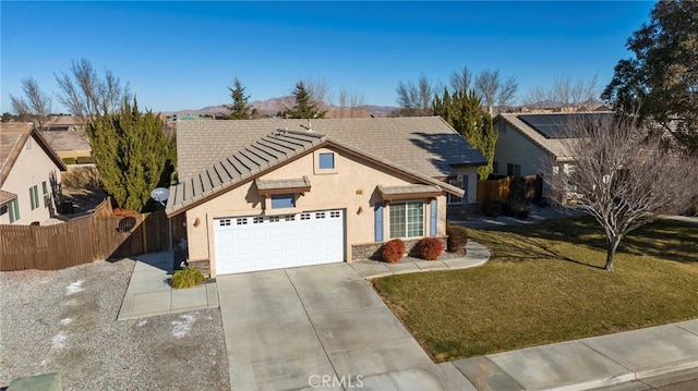 view of front of house featuring a garage and a front yard