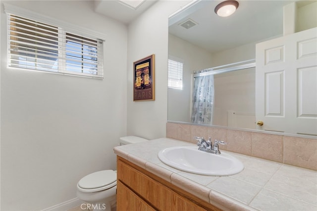 bathroom with vanity, toilet, and a shower with shower curtain