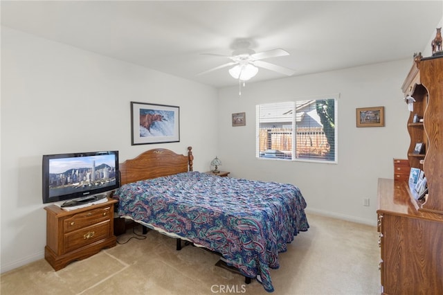 bedroom with light colored carpet and ceiling fan