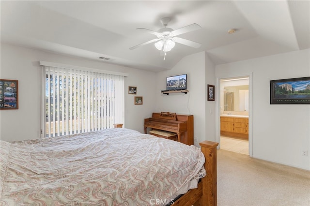 bedroom featuring connected bathroom, light colored carpet, and ceiling fan