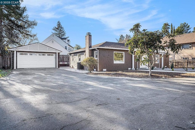 ranch-style house featuring cooling unit and a garage