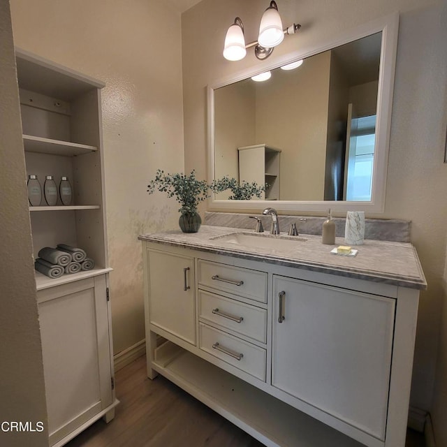 bathroom with vanity, hardwood / wood-style floors, and built in features