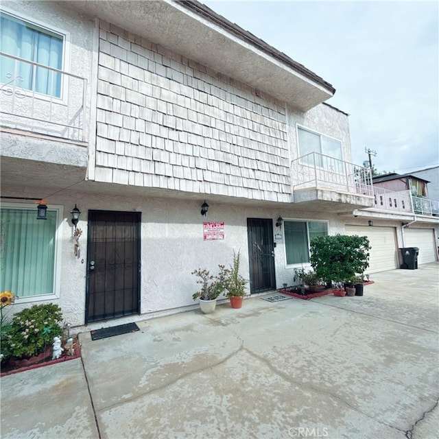 property entrance with a garage and a balcony