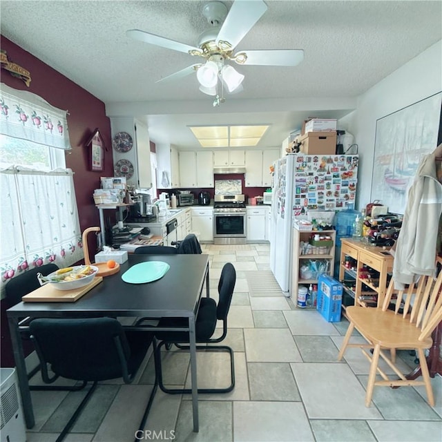 dining room with ceiling fan and a textured ceiling