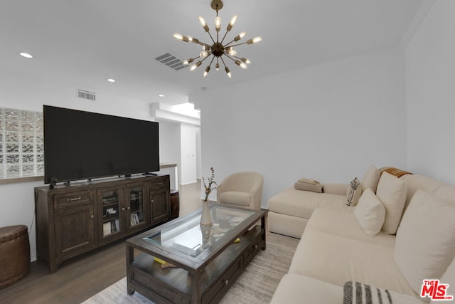 living room featuring a notable chandelier and light hardwood / wood-style floors