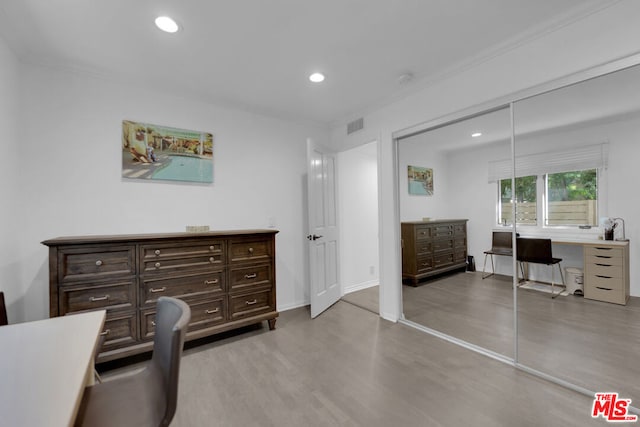 office featuring crown molding and light hardwood / wood-style floors