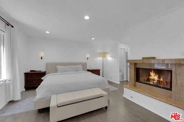 bedroom featuring crown molding and hardwood / wood-style flooring